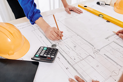 Contractor examining building blueprint